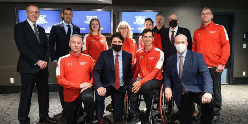 Invictus Games staff and the Canadian President in a conference room